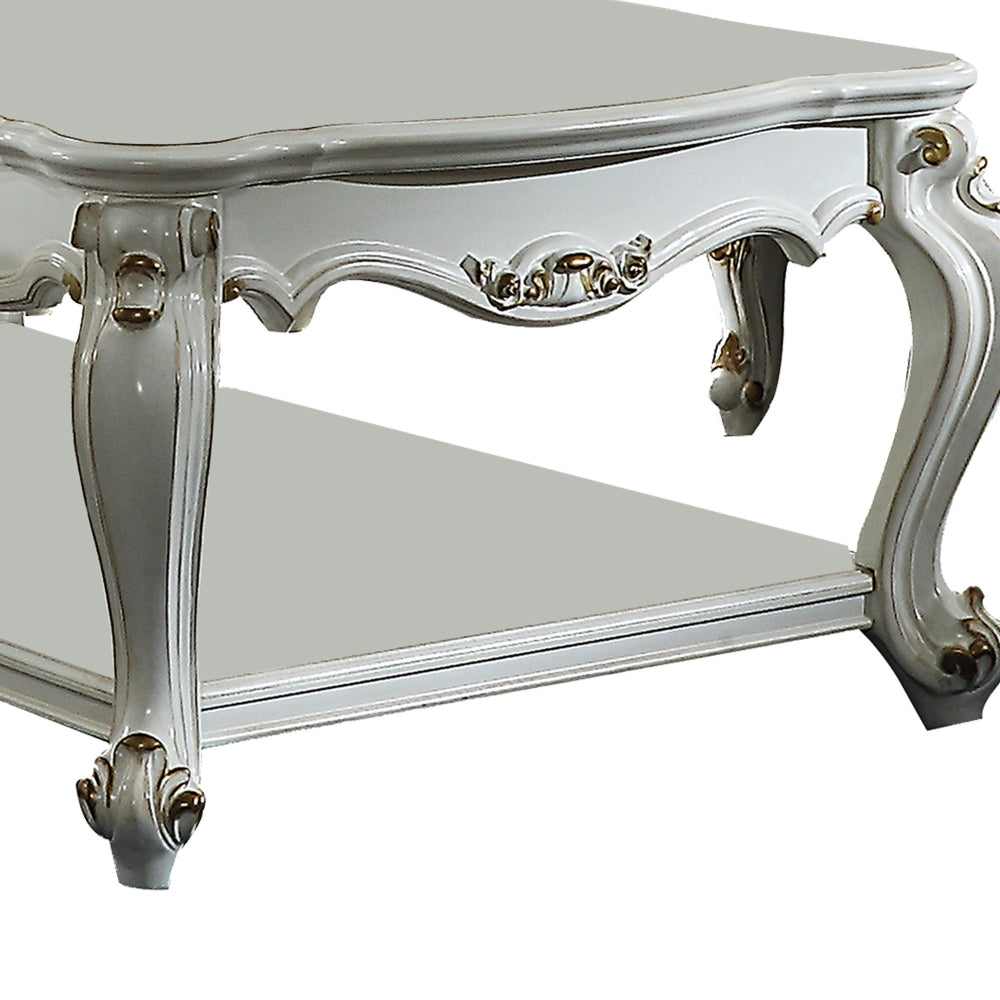 Benjara Traditional Style Wooden Coffee Table with Polyresin Carvings And Bottom Shelf, White