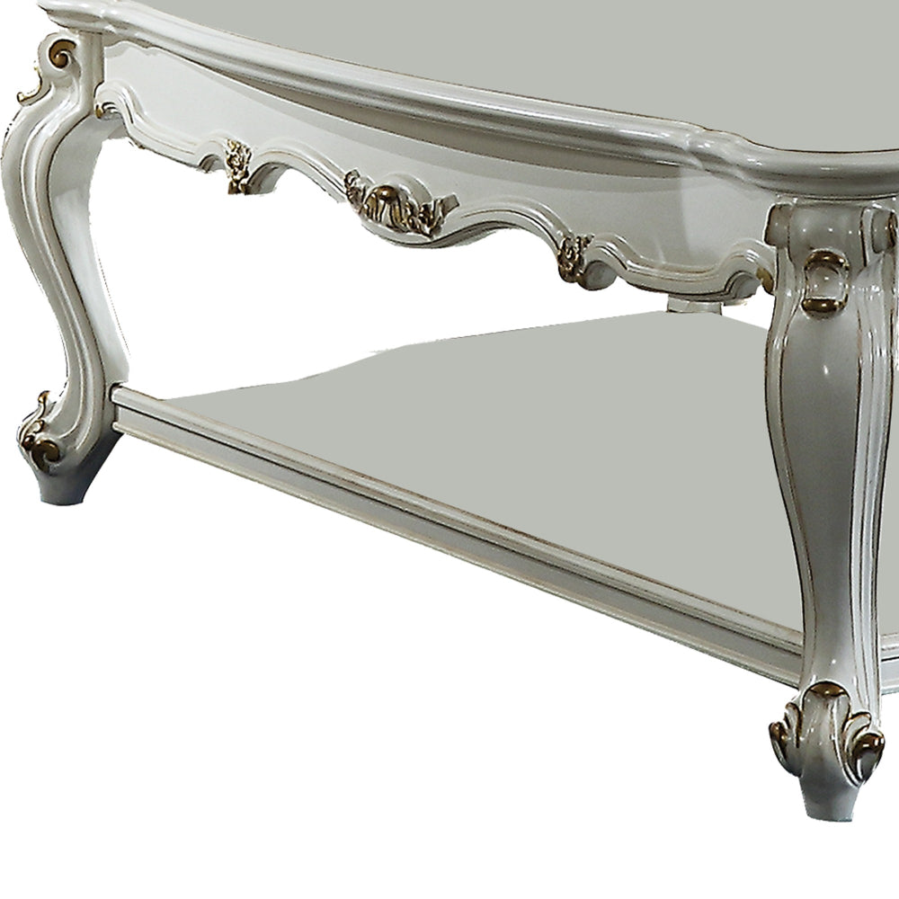 Benjara Traditional Style Wooden Coffee Table with Polyresin Carvings And Bottom Shelf, White