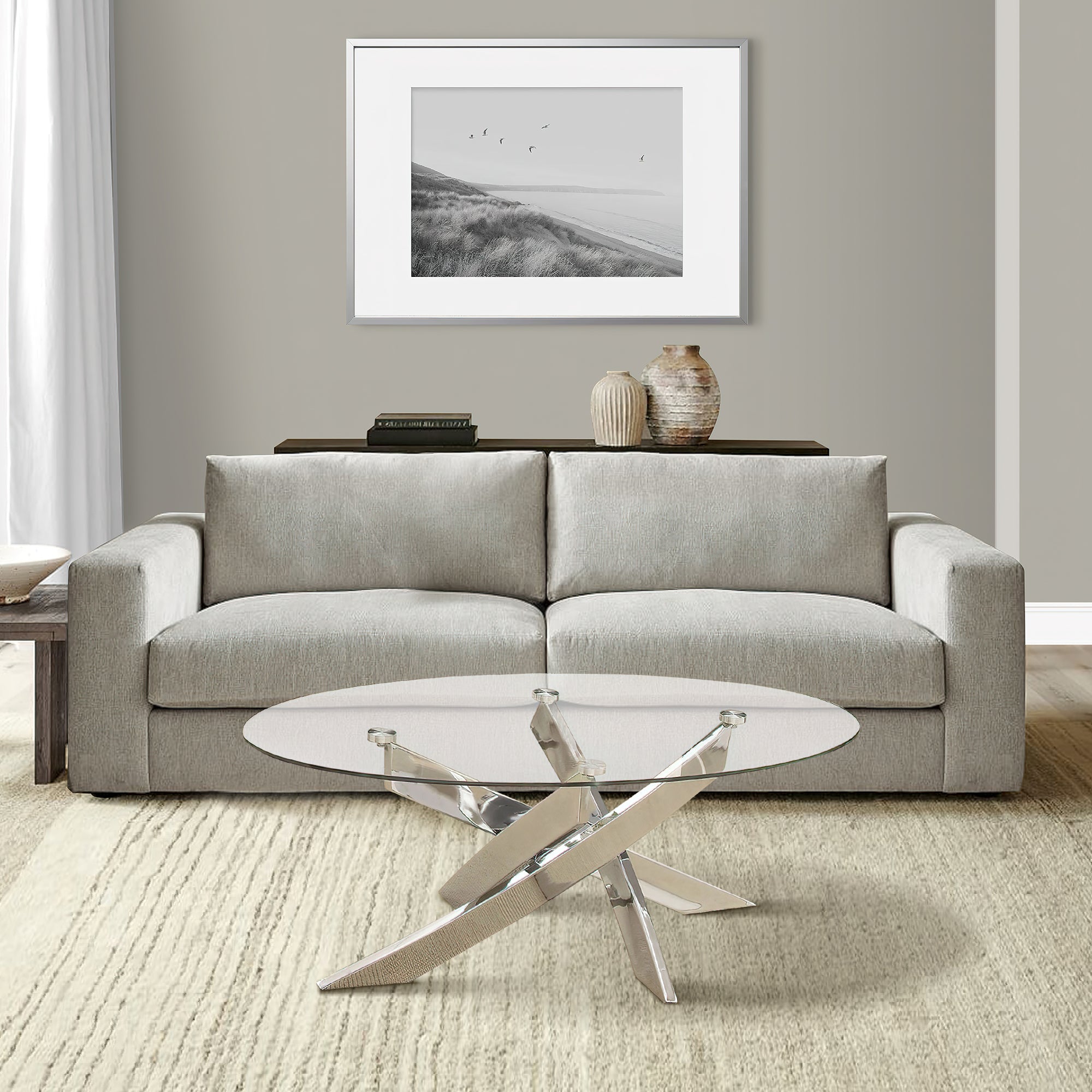 Benjara Oval Shape Glass Top Coffee Table with Criss Cross Base, Silver And Clear