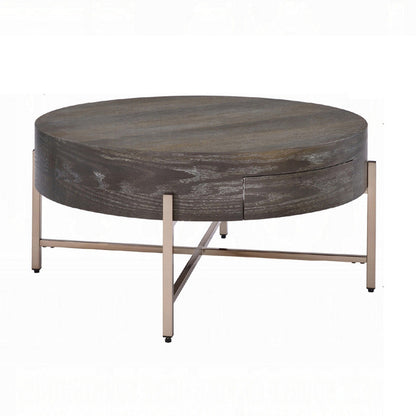 Benjara 1 Drawer Round Modern Coffee Table with Crossed Metal Legs, Brown And Gold