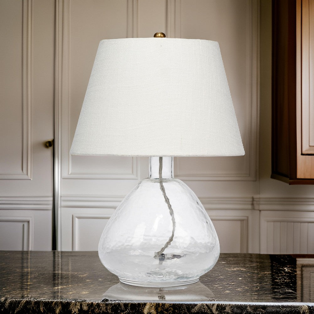 Benjara Navi 17 Inch Table Lamp, White Linen Drum Shade, Clear Glass Curved Body