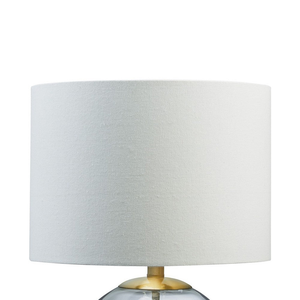 Benjara 21 Inch Table Lamp, White Drum Shade, Round Clear Glass Base, Brass Metal