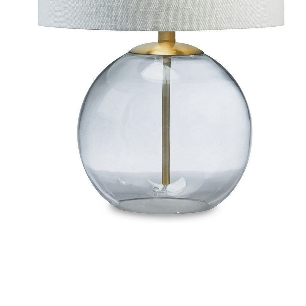 Benjara 21 Inch Table Lamp, White Drum Shade, Round Clear Glass Base, Brass Metal