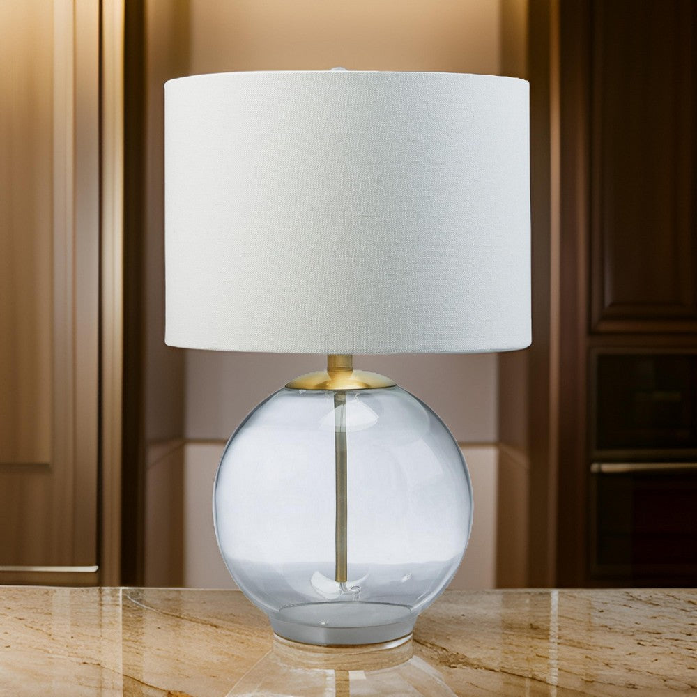Benjara 21 Inch Table Lamp, White Drum Shade, Round Clear Glass Base, Brass Metal